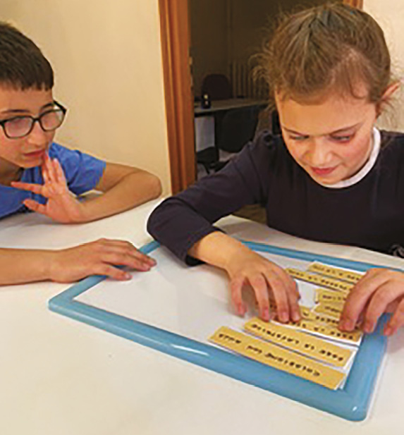 Two children reviewing the steps of a recipe